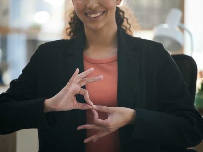 Hand gesture, corporate and woman at work for communication, sign language or working. Smile, offic.